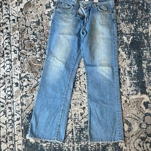 Button fly Lucky brand slightly distressed blue jeans.